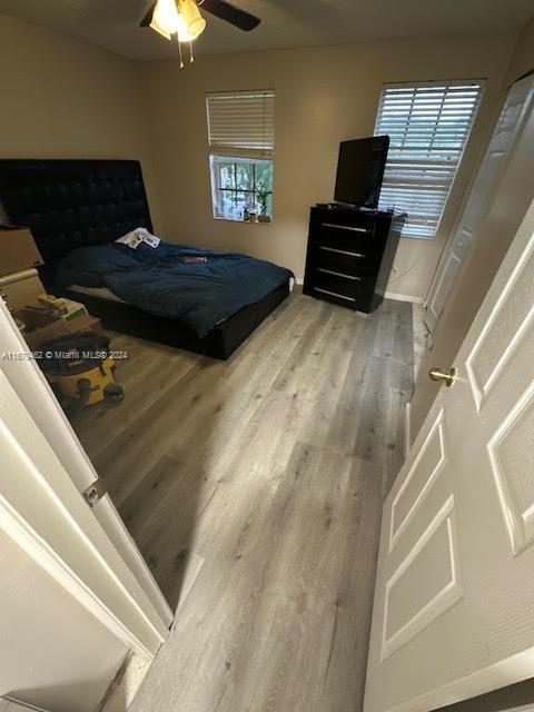 bedroom with ceiling fan and hardwood / wood-style floors