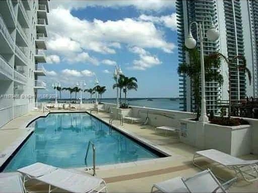 view of pool featuring a water view