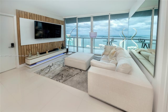 living room with tile patterned floors and floor to ceiling windows