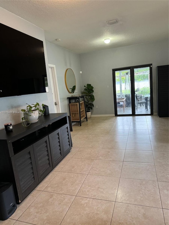 tiled living room with a textured ceiling