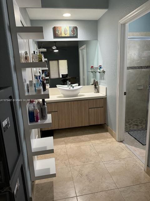 bathroom featuring vanity, tile patterned floors, and a shower with shower door