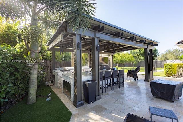 view of patio with a gazebo, an outdoor bar, and an outdoor kitchen