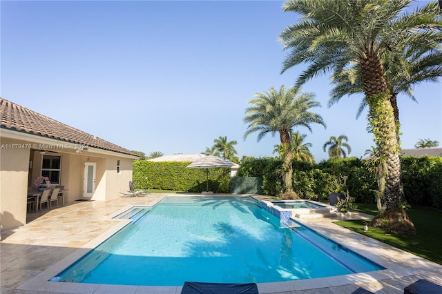 view of swimming pool featuring an in ground hot tub and a patio area