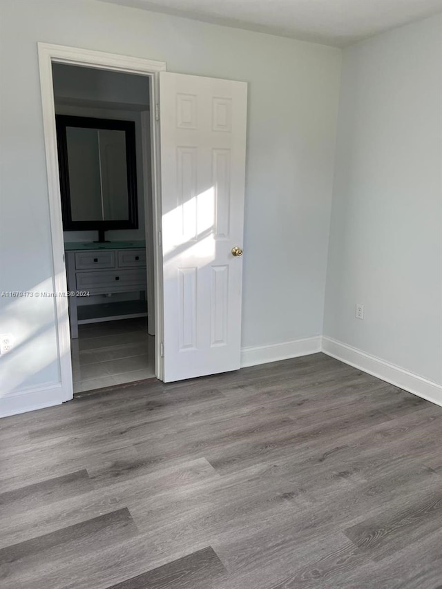 spare room featuring wood-type flooring