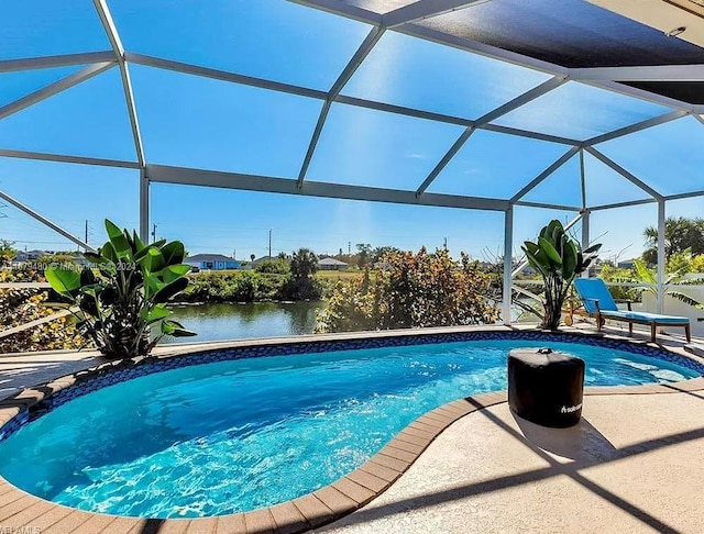 view of swimming pool featuring a water view, a patio area, and glass enclosure