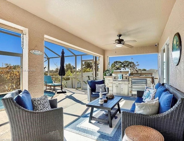 view of patio / terrace with ceiling fan, a lanai, an outdoor kitchen, and an outdoor hangout area