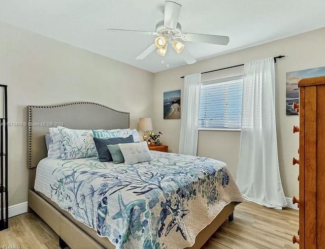 bedroom with light wood-type flooring and ceiling fan