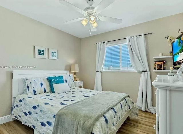 bedroom with ceiling fan and light wood-type flooring