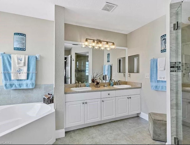 bathroom featuring vanity, tile patterned floors, and shower with separate bathtub