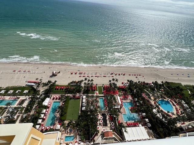 birds eye view of property featuring a view of the beach and a water view