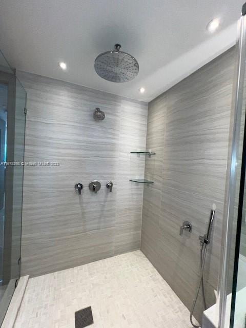 bathroom with tiled shower