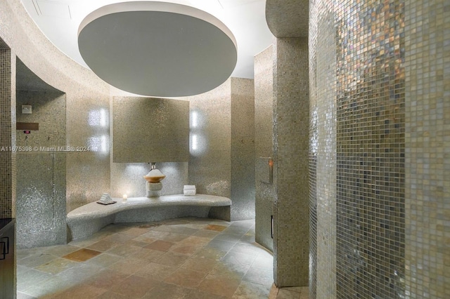 bathroom featuring tile walls