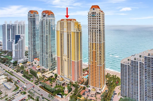 view of property featuring a view of the beach and a water view