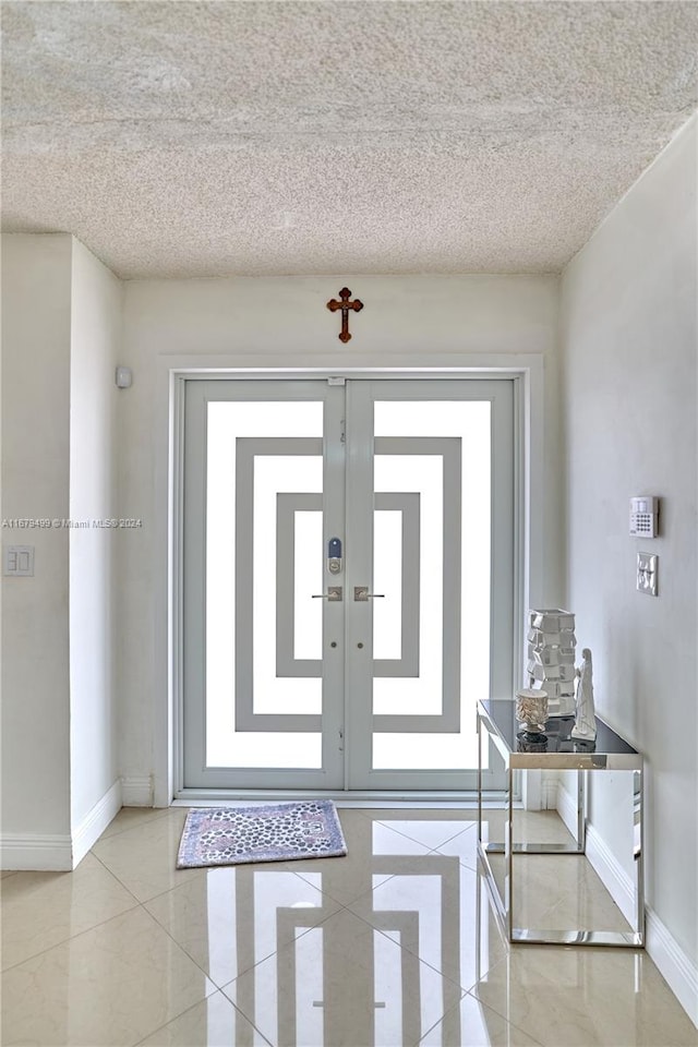 foyer entrance with a textured ceiling