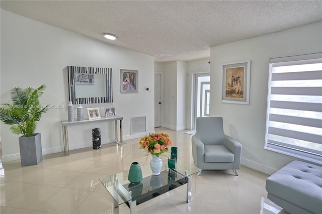 tiled living room featuring lofted ceiling and a textured ceiling