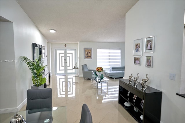 interior space featuring french doors and a textured ceiling