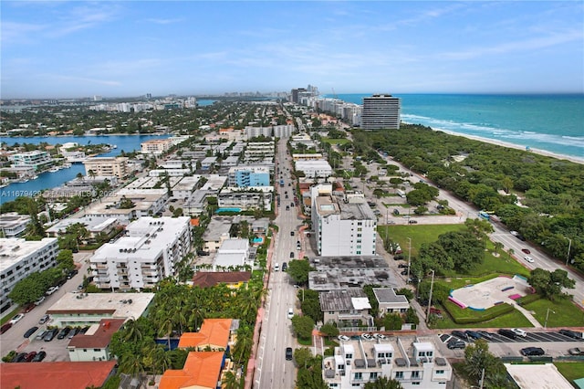 birds eye view of property featuring a water view and a view of the beach