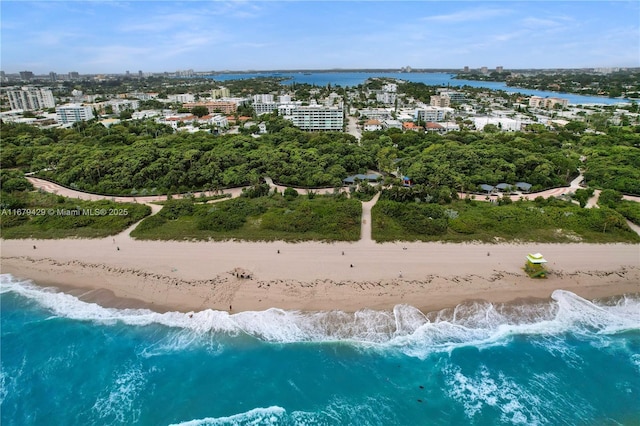 drone / aerial view featuring a water view and a view of the beach