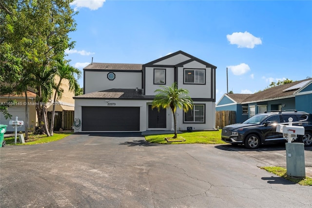 view of front of home with a front yard and a garage