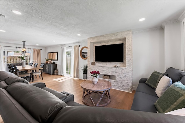 living room featuring a textured ceiling and light hardwood / wood-style floors