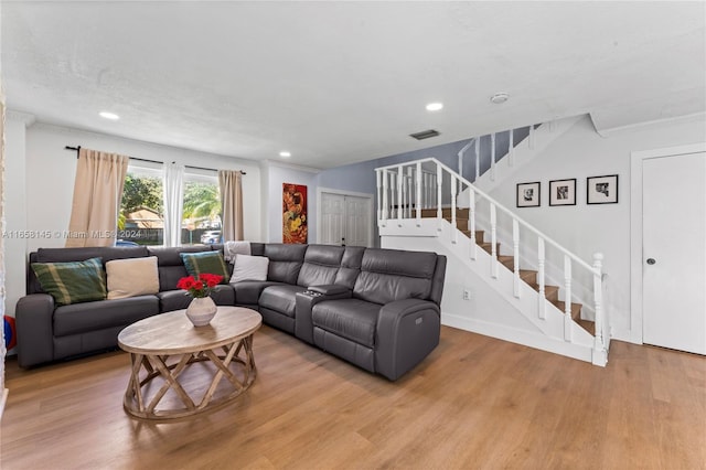 living room featuring light hardwood / wood-style flooring and a textured ceiling