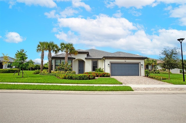 view of front of home with an attached garage, a front lawn, decorative driveway, and stucco siding