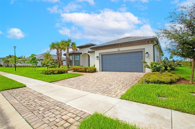 view of front of home with a front yard and a garage