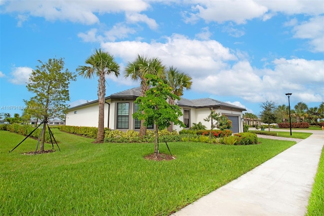 view of front of house with a front lawn and a garage