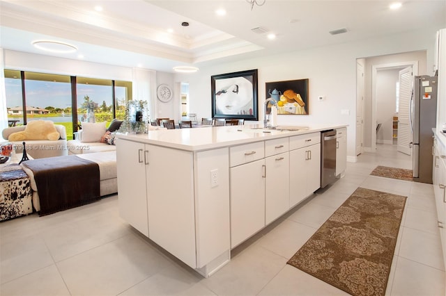 4527 Blessed Place Dr, Oakland Park, FL 33309 - kitchen featuring a sink, open floor plan, appliances with stainless steel finishes, white cabinetry, and a kitchen island with sink