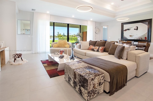 living area featuring light tile patterned floors, visible vents, a tray ceiling, crown molding, and recessed lighting