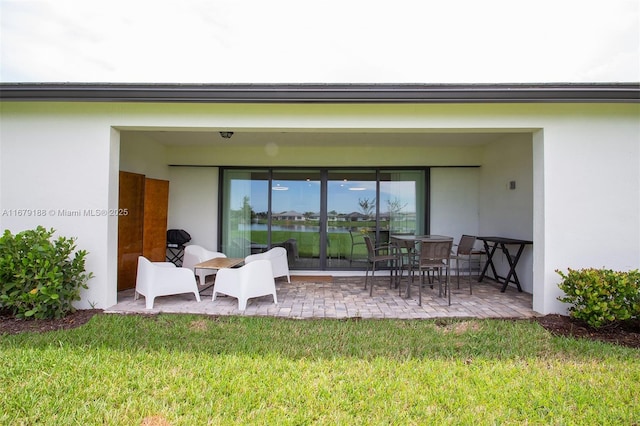 4527 Blessed Place Dr, Oakland Park, FL 33309 - rear view of property featuring a yard, a patio, and stucco siding