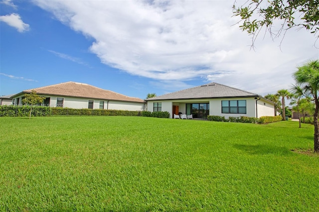 4527 Blessed Place Dr, Oakland Park, FL 33309 - back of property with a lawn and stucco siding