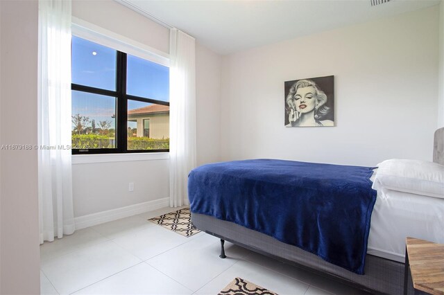 bedroom featuring light tile patterned flooring