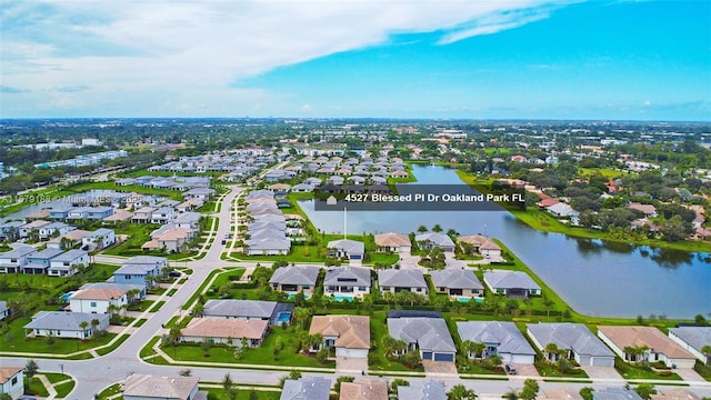 bird's eye view featuring a water view and a residential view