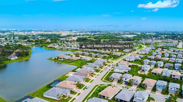 drone / aerial view with a residential view and a water view