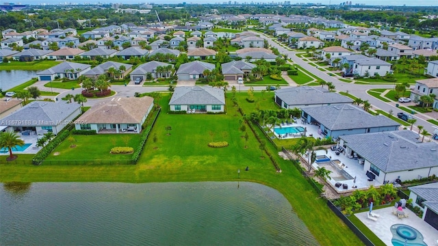 birds eye view of property with a residential view and a water view