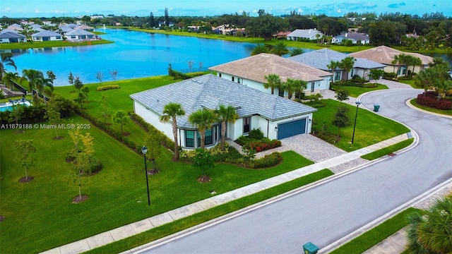 drone / aerial view with a water view and a residential view