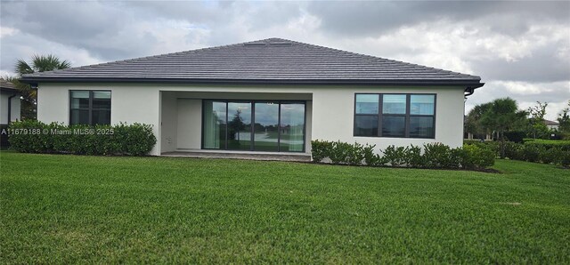 4527 Blessed Place Dr, Oakland Park, FL 33309 - rear view of property featuring stucco siding and a lawn
