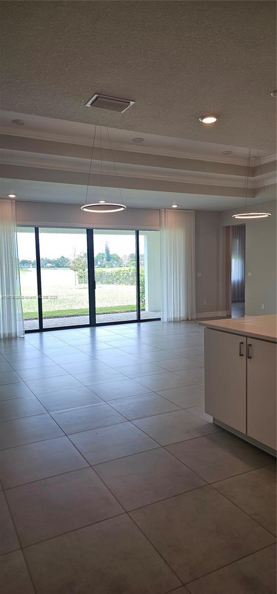 4527 Blessed Place Dr, Oakland Park, FL 33309 - empty room with light tile patterned flooring, recessed lighting, crown molding, and a textured ceiling