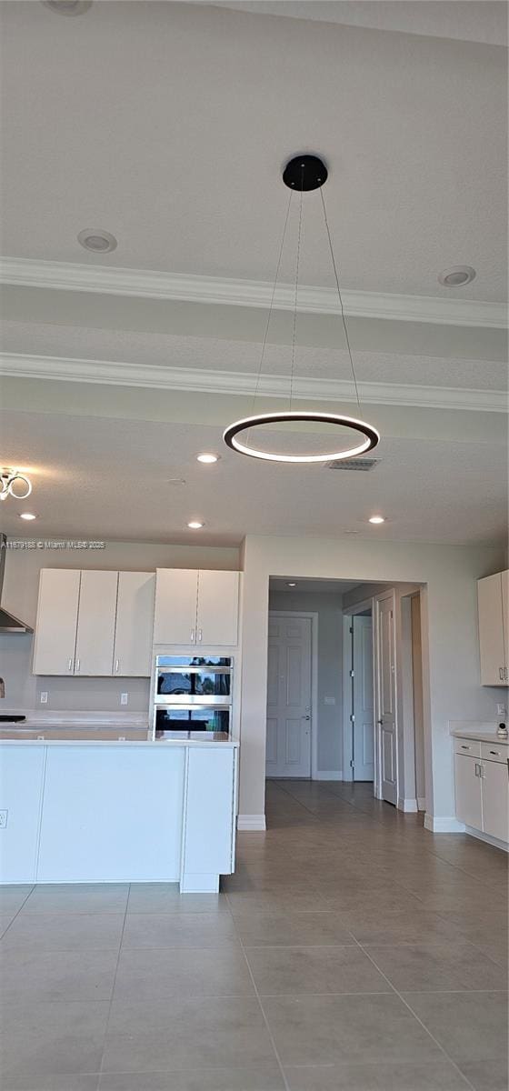 4527 Blessed Place Dr, Oakland Park, FL 33309 - kitchen featuring ornamental molding, exhaust hood, white cabinets, light countertops, and tile patterned floors