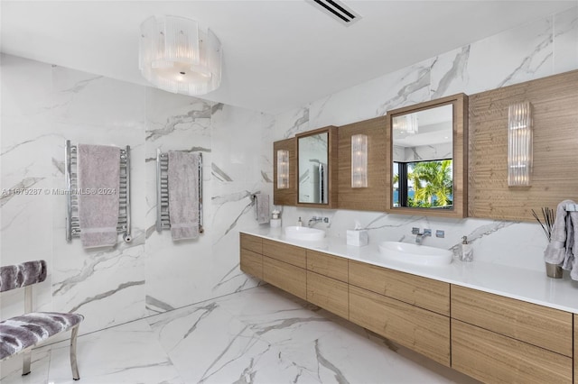 bathroom with tile walls, vanity, and radiator heating unit