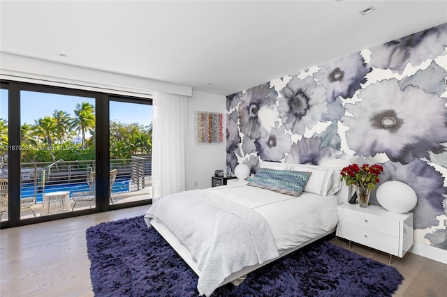 bedroom featuring hardwood / wood-style floors and access to exterior