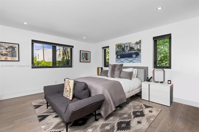 bedroom featuring dark wood-type flooring and multiple windows