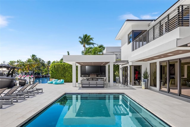 view of pool featuring a water view and a patio area