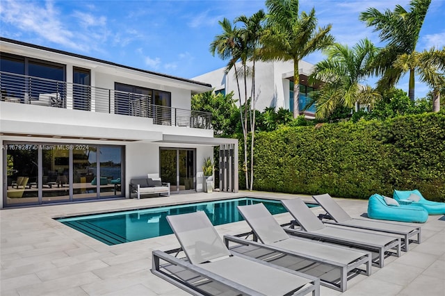 view of pool with an outdoor living space and a patio area