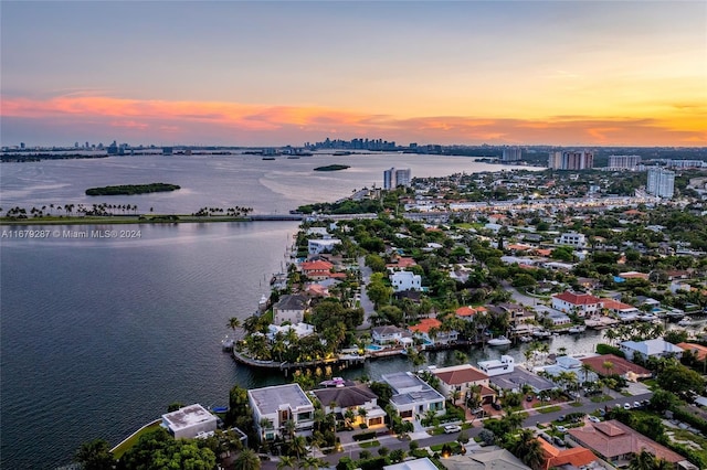 aerial view at dusk with a water view