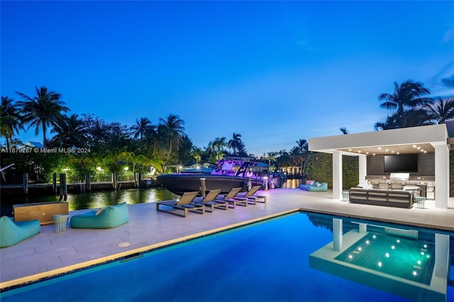 view of swimming pool with a patio and an outdoor kitchen