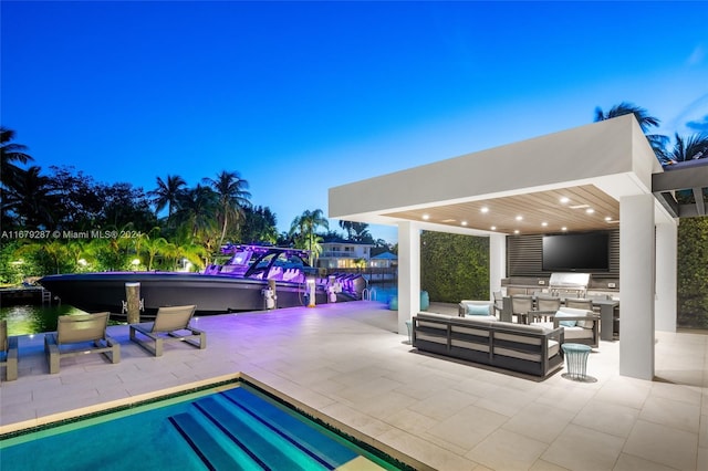 view of swimming pool featuring a water view, a patio area, and outdoor lounge area