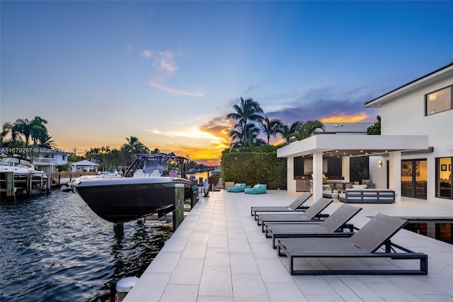 exterior space featuring outdoor lounge area and a water view