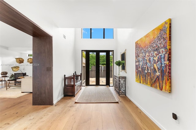 foyer entrance featuring light hardwood / wood-style flooring and french doors